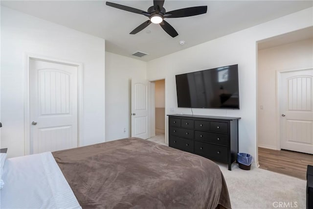 bedroom with visible vents, baseboards, carpet flooring, and a ceiling fan