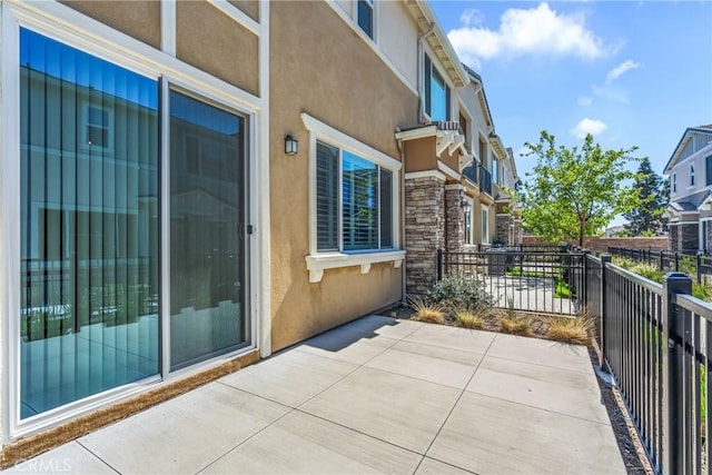 view of patio with a residential view and fence