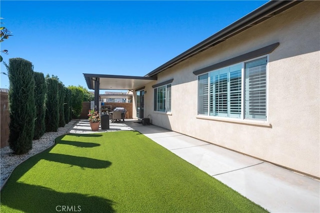 view of yard featuring a patio area and a fenced backyard