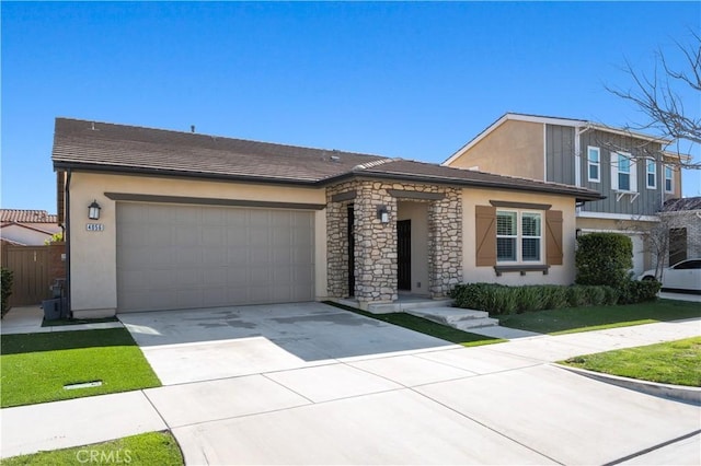 view of front facade featuring a garage, stone siding, concrete driveway, and stucco siding