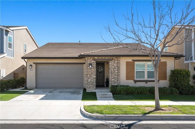 view of front of house with a garage, stone siding, a tile roof, and stucco siding