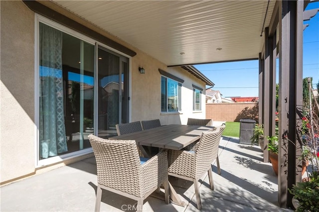 view of patio / terrace with outdoor dining area and fence