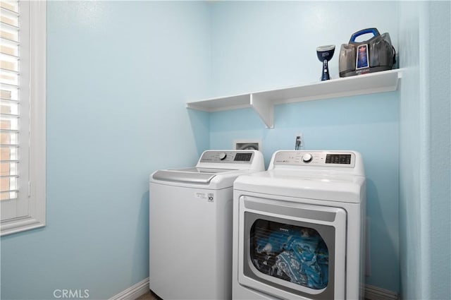 washroom featuring laundry area and washing machine and clothes dryer