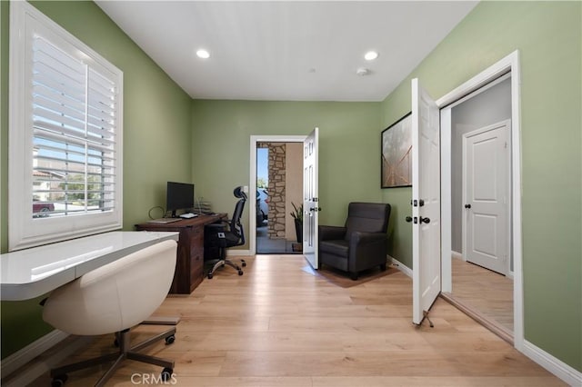 home office with recessed lighting, light wood-style flooring, and baseboards