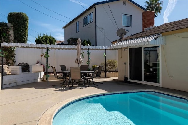 view of swimming pool with a patio area, a fenced in pool, outdoor dining area, and fence