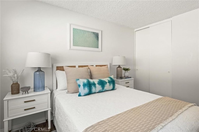 bedroom with a closet and a textured ceiling