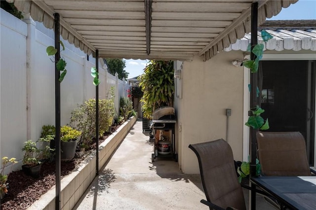 view of patio featuring fence