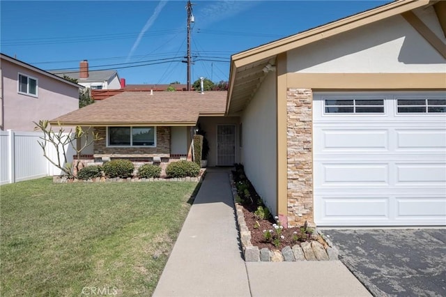 view of front of home featuring a front yard, fence, stucco siding, a garage, and stone siding