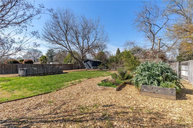 view of yard featuring a garden and a fenced backyard