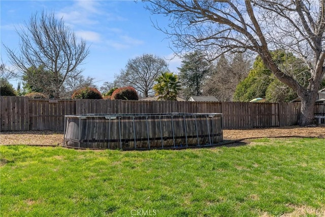 view of yard with a fenced in pool and a fenced backyard