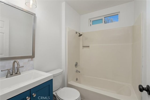 bathroom featuring decorative backsplash, toilet, vanity, and shower / tub combination