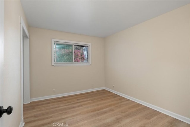 unfurnished bedroom featuring light wood-style flooring and baseboards