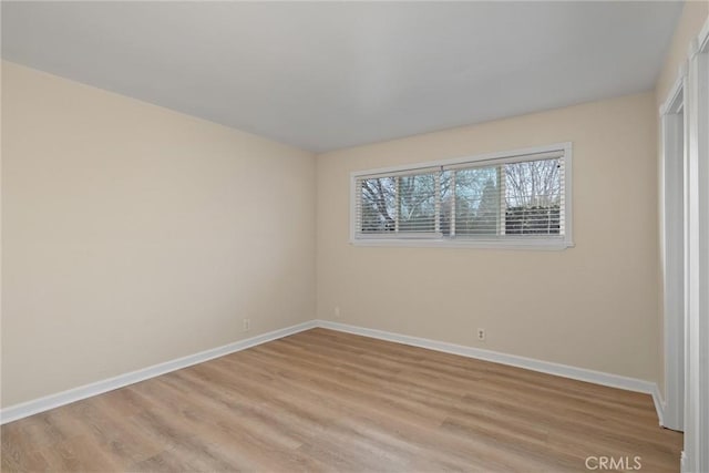 interior space featuring baseboards and light wood-style floors