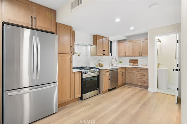 kitchen featuring light countertops, light wood-style floors, visible vents, and appliances with stainless steel finishes