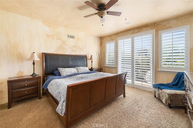 carpeted bedroom featuring visible vents, ceiling fan, and access to outside