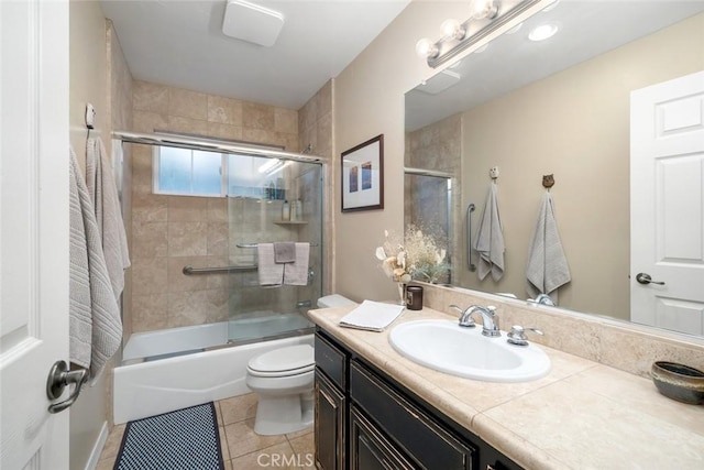 bathroom featuring vanity, toilet, combined bath / shower with glass door, and tile patterned flooring