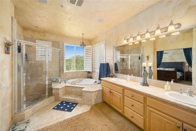 bathroom featuring visible vents, double vanity, a sink, a shower stall, and a garden tub