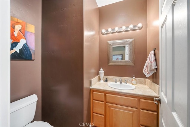 bathroom with toilet and vanity