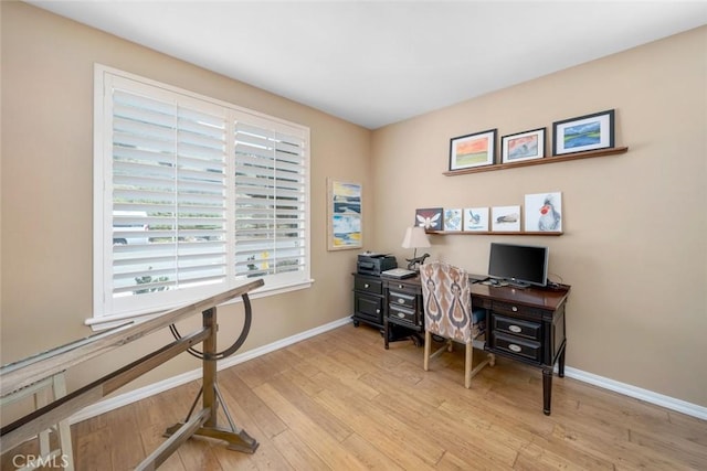 home office featuring baseboards and wood finished floors