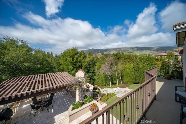 balcony featuring a mountain view and a patio