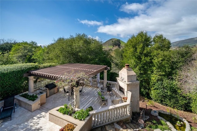 surrounding community with outdoor dining area, a patio area, and a mountain view