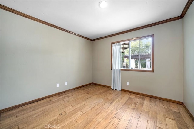 unfurnished room with baseboards, light wood-type flooring, and ornamental molding