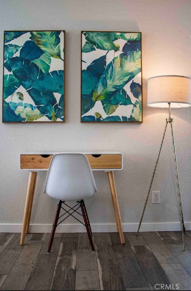 dining area with baseboards and wood finished floors