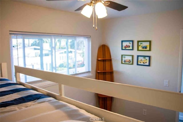 bedroom with multiple windows and a ceiling fan