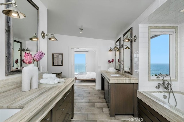 426 Monarch Bay Dr, Dana Point, CA 92629 - ensuite bathroom featuring a sink, two vanities, lofted ceiling, ensuite bathroom, and a bath