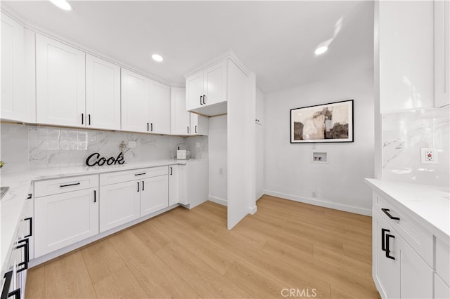 kitchen featuring recessed lighting, decorative backsplash, light wood-style floors, and white cabinetry