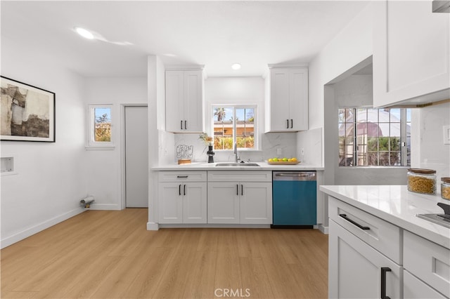 kitchen with dishwasher, light countertops, white cabinets, and tasteful backsplash