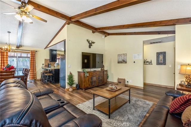 living room featuring lofted ceiling with beams, wood finished floors, baseboards, and visible vents