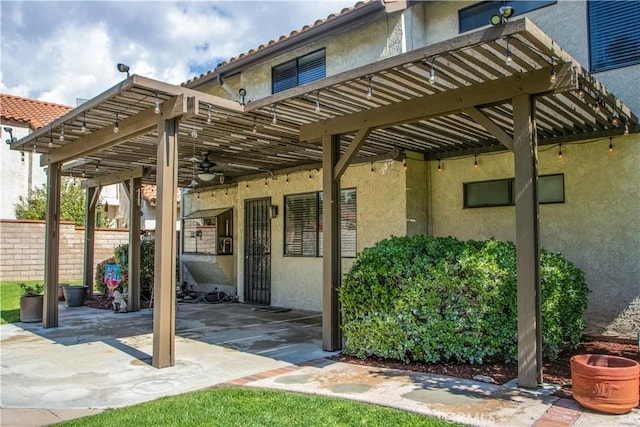 view of patio with a pergola and fence