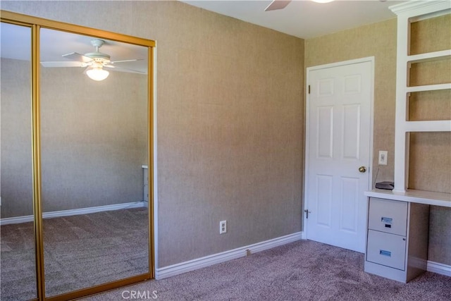 unfurnished bedroom featuring a closet, baseboards, a ceiling fan, and carpet