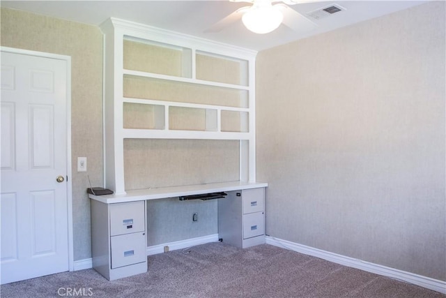 unfurnished office featuring visible vents, baseboards, ceiling fan, and carpet floors