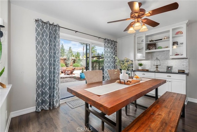 dining space with a ceiling fan, dark wood-type flooring, and baseboards