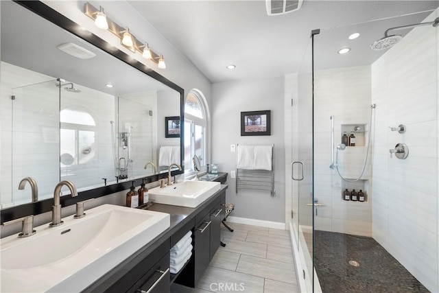 full bath featuring a sink, visible vents, and a stall shower