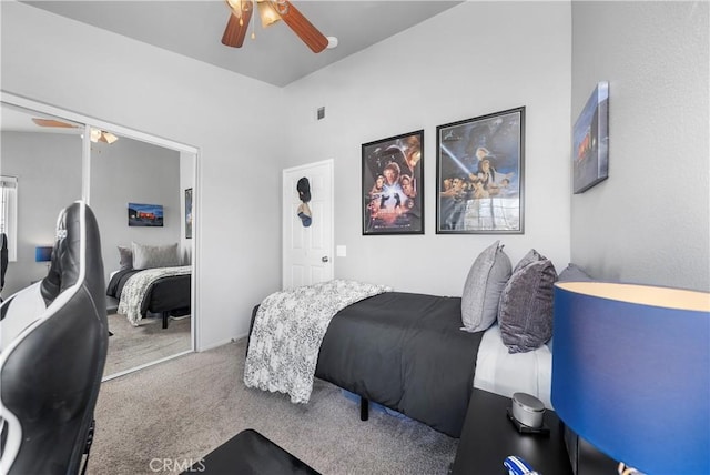 bedroom featuring a ceiling fan, a closet, and carpet floors