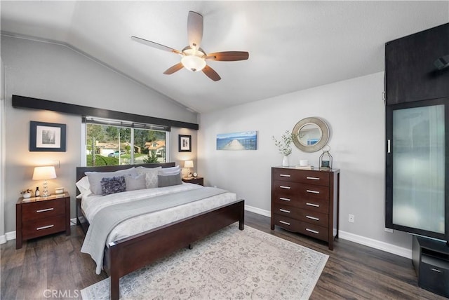 bedroom with dark wood finished floors, ceiling fan, baseboards, and vaulted ceiling