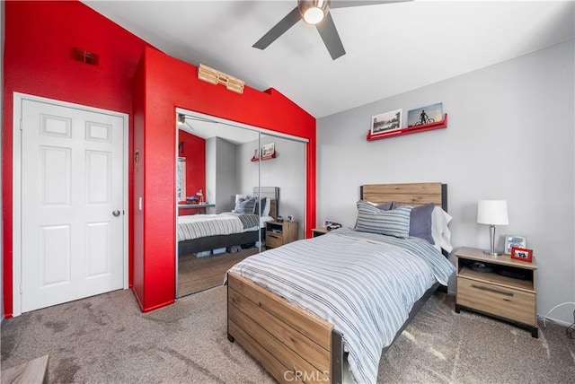 bedroom featuring a closet, visible vents, carpet flooring, and vaulted ceiling