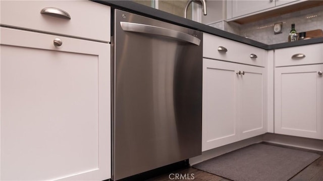 interior details featuring dark countertops, white cabinets, and dishwasher