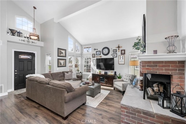 living area featuring plenty of natural light, dark wood-style floors, and a fireplace