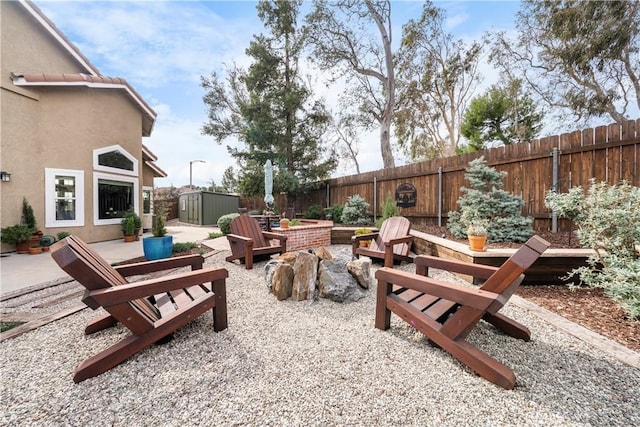 view of patio with a fenced backyard, a storage shed, and an outdoor structure