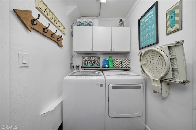 laundry room featuring washing machine and dryer and cabinet space