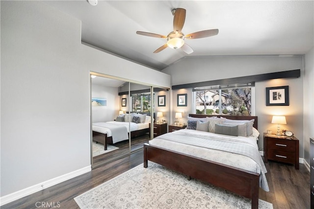 bedroom featuring wood finished floors, baseboards, ceiling fan, vaulted ceiling, and a closet