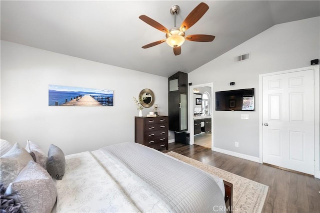 bedroom with visible vents, wood finished floors, baseboards, ceiling fan, and vaulted ceiling