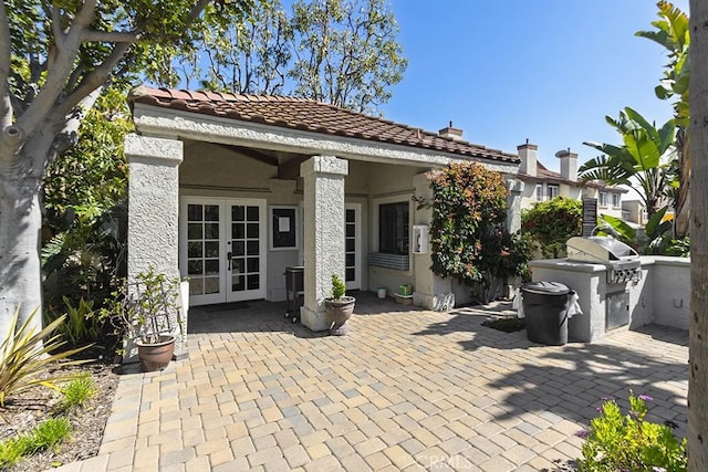 view of patio featuring french doors and a grill