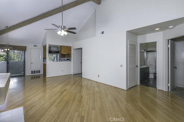 unfurnished living room with beam ceiling, light wood-style flooring, ceiling fan with notable chandelier, and visible vents