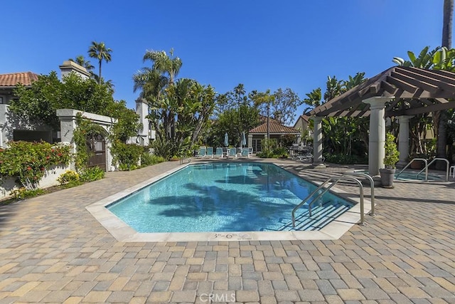 pool featuring a patio area and a pergola