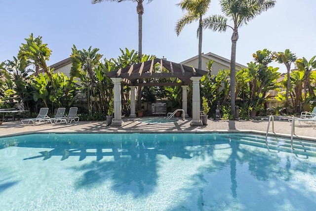 pool featuring a patio, a community hot tub, and a pergola